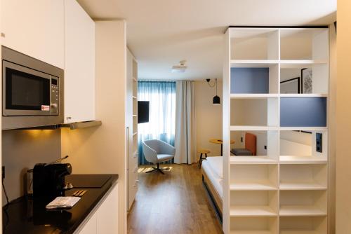 a hotel room with a bed and a desk at smartments Wien Heiligenstadt in Vienna