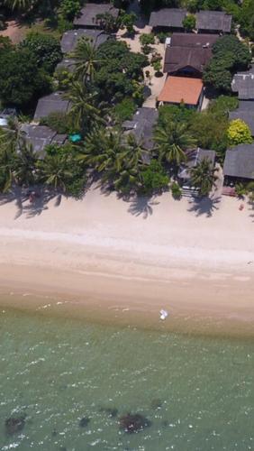 an aerial view of a beach with houses and the water at Bangpo Village Tiny Country Beach House in Ban Bang Po