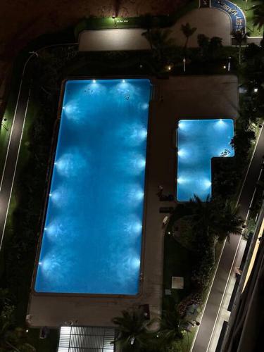 an overhead view of a swimming pool at night at Apartement 2BR sky house BSD in Cilenggang