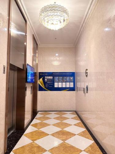 a lobby with a hallway with a chandelier and ailed floor at Apartement 2BR sky house BSD in Cilenggang
