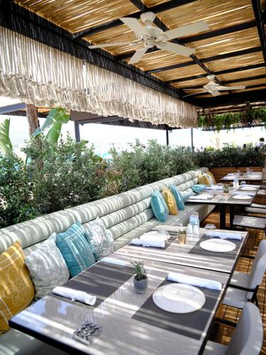 a dining room with tables and chairs on a patio at Kuum Hotel & Spa in Golturkbuku