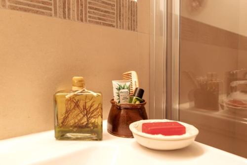 a bathroom counter with a bottle of soap and a toothbrush at Feldhasen in Bad Ischl