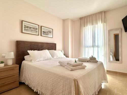 a bedroom with a bed with towels on it at Porto Azul 10A Frontal Peñon & Sea View First Line Arenal Beach in Calpe