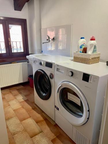 a white washer and dryer in a kitchen at StaraGo Attic Suite - Elegante mansarda in centro storico in Gorizia