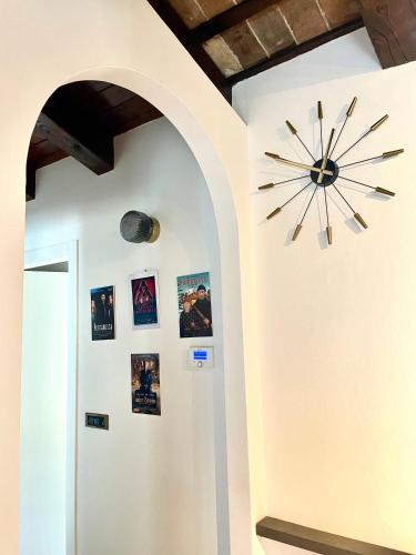 a clock on a wall with pictures on it at StaraGo Attic Suite - Elegante mansarda in centro storico in Gorizia