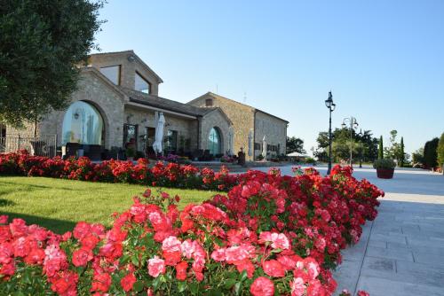 a group of flowers in front of a building at Postiglione Country House in Cingoli
