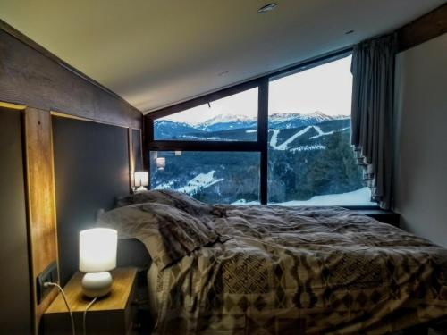 a bedroom with a large window with a mountain view at Magic Borda Cremat HUT4-5018 in La Massana