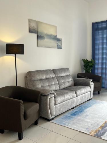 a living room with a couch and a chair at SSR312/S2TOWN/3R2B HOMESTAY in Seremban