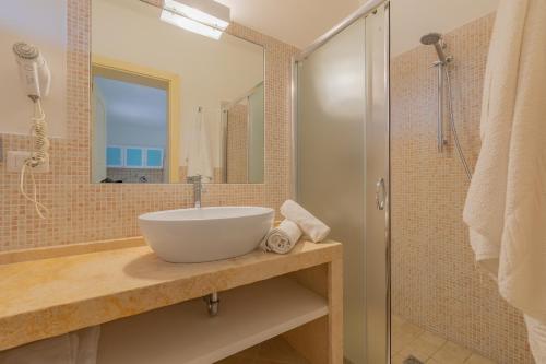 a bathroom with a sink and a shower at Cava Li Santi Residence in Nardò