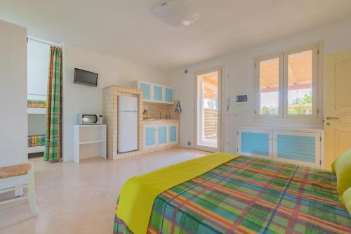 a large bedroom with a bed and a kitchen at Cava Li Santi Residence in Nardò
