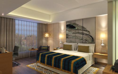 a hotel room with a bed and a window at WOW Crest, Indore - IHCL SeleQtions in Indore