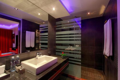 a bathroom with a sink and a mirror at Absolute Bangla Suites in Patong Beach