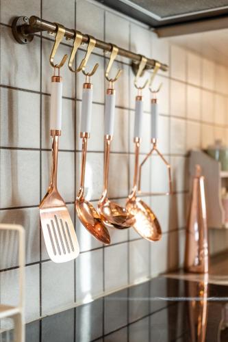 a group of utensils hanging on a kitchen wall at Black Velvet in Agkidia