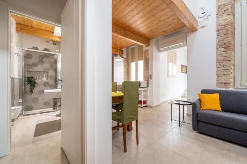 a living room and dining room with a blue couch at A Casa di Gianna in Cagliari