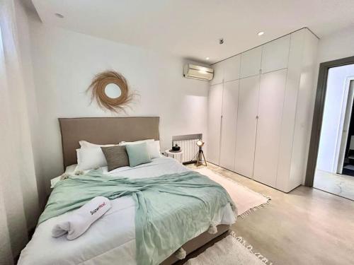 a bedroom with a large bed and a large window at Baïa Appartment in La Marsa