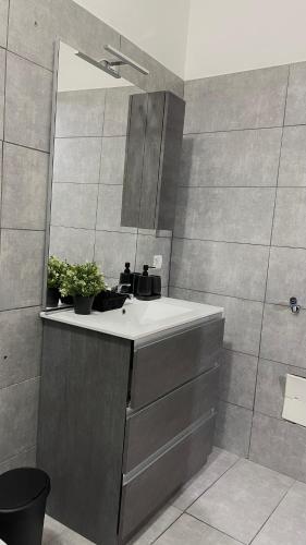 a bathroom with a sink and a mirror at House Capodichino in Naples