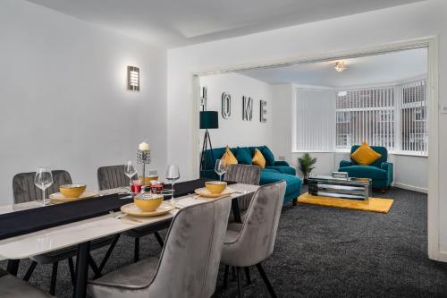 a living room with a table and chairs and a couch at Borrowdale Brook in Leeds