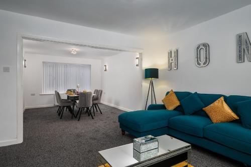 a living room with a blue couch and a table at Borrowdale Brook in Leeds