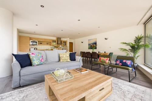 a living room with a couch and a table at ExCel London Spacious 3 Bedroom - Royal Docks in London