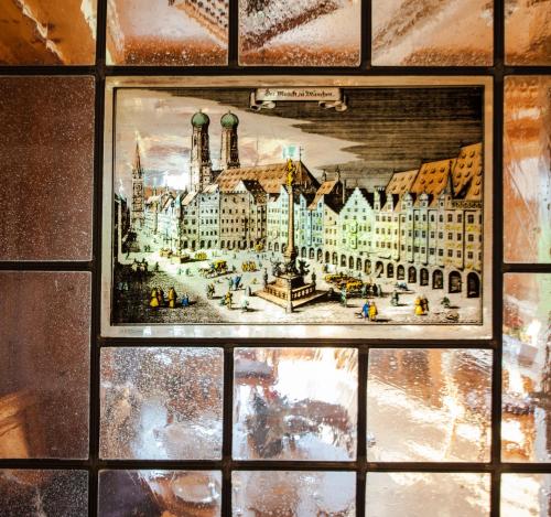 a painting of a building on a glass window at Relais & Châteaux Gut Steinbach Hotel Chalets SPA in Reit im Winkl