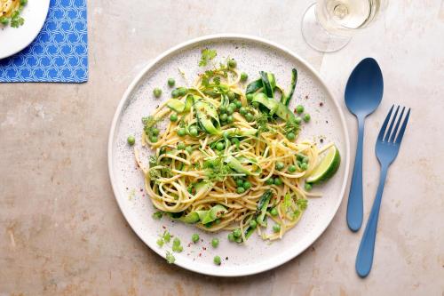 a plate of pasta with vegetables on a table at Robinson Soma Bay in Hurghada