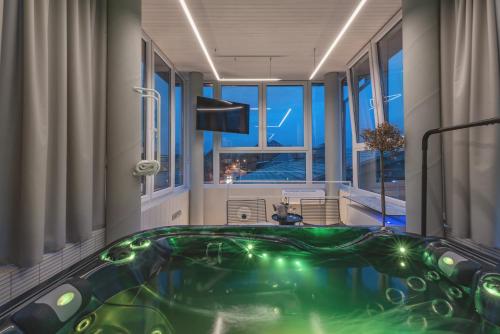 a jacuzzi tub in a room with a window at SPA apartamentai Palanga in Palanga