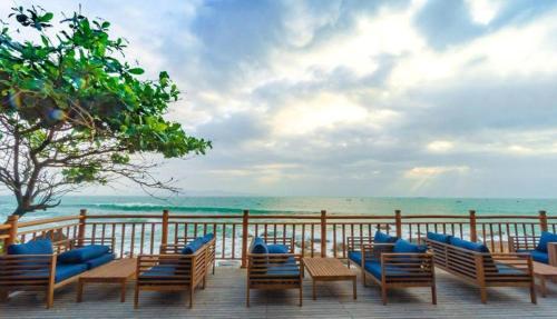 a deck with chairs and a view of the ocean at Resort Bai Xep Quy Nhon in Quy Nhon