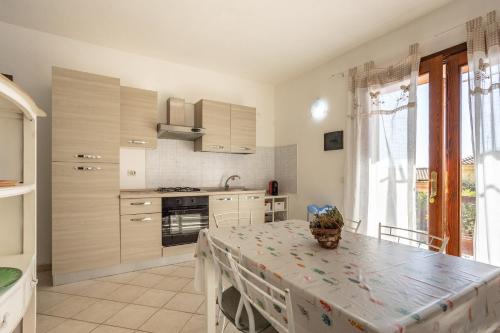 a kitchen with a table with a table cloth on it at Casa Orimar 419 in Badesi