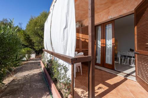 a patio with an umbrella on the side of a house at Casa Orimar 419 in Badesi