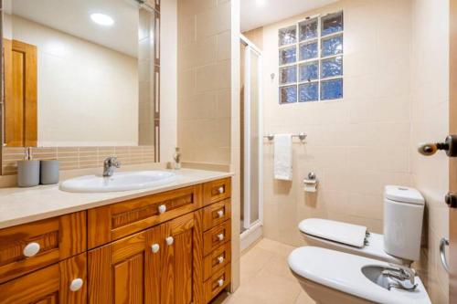 a bathroom with a sink and a toilet and a mirror at Holiday Home Valencia in Riba-Roja De Turia