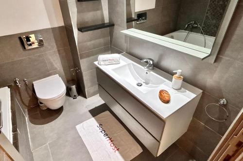 a bathroom with a sink and a toilet and a mirror at Dream Appartment in La Marsa