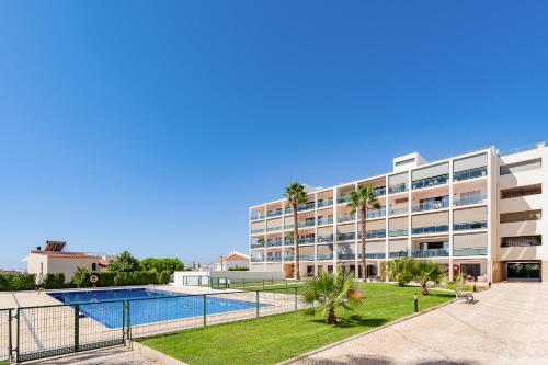 a large apartment building with a swimming pool at Fernanda`s hideaway in Olhão