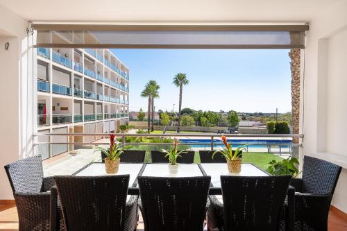 a dining room with a table and chairs and a large window at Fernanda`s hideaway in Olhão