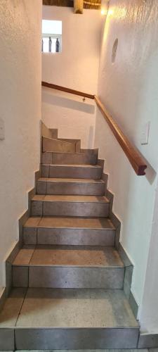 a set of stairs in a building with a stair case at Serenity Jacobsbay in Jacobs Bay