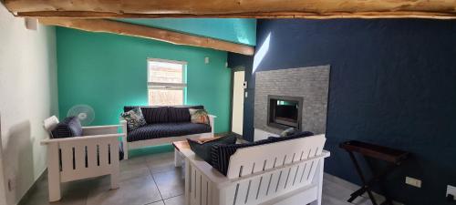 a living room with a couch and a fireplace at Serenity Jacobsbay in Jacobs Bay