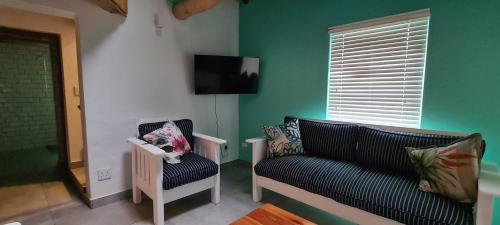 a living room with a couch and a chair at Serenity Jacobsbay in Jacobs Bay