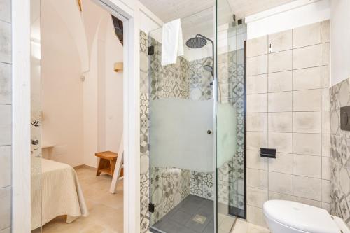 a bathroom with a shower with a toilet and a sink at Dimora Ferente in Salve