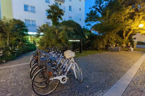 a row of bikes parked next to a building at Albergo alla Spiaggia in Grado