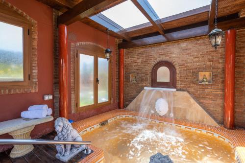 a hot tub in a room with a fountain at Villa Torres Motril in Motril