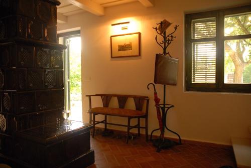 a living room with a tv and a chair at Sárga Ház in Káptalantóti