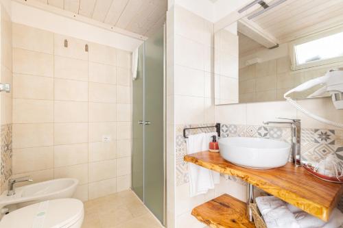 a bathroom with a sink and a toilet at Dimora Ferente in Salve