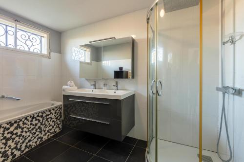 een badkamer met een wastafel en een douche bij Maison Carrosse - A 20min de Bordeaux in Martillac