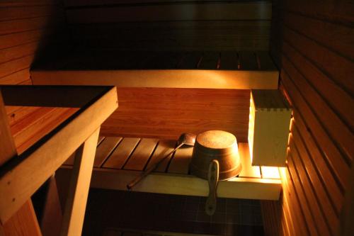 a sauna with a barrel and a pot in it at Santa's Hotel Rudolf in Rovaniemi