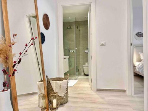 a bathroom with a toilet and a mirror in a room at Le Bohémien in La Marsa