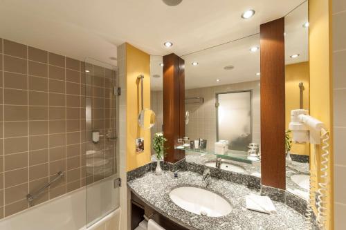 a bathroom with a sink and a shower at Essential by Dorint Frankfurt-Niederrad in Frankfurt/Main