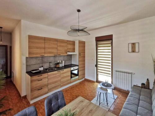 a kitchen with a couch and a table in a room at Apartman Central Square in Gospić
