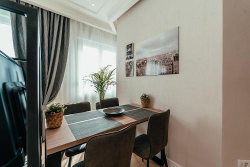 a dining room with a table and chairs at Biarritz Luxury Apartments in Belgrade