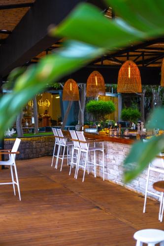 a row of white chairs and tables in a bar at Kuum Hotel & Spa in Golturkbuku