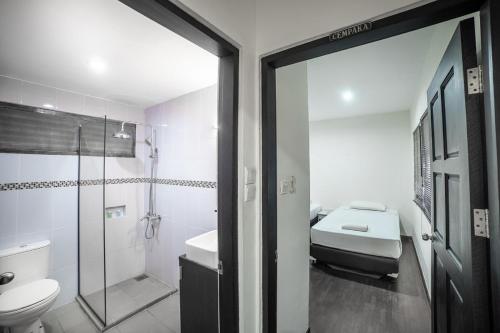 a bathroom with a toilet and a sink and a shower at Nongsa Point Marina in Nongsa