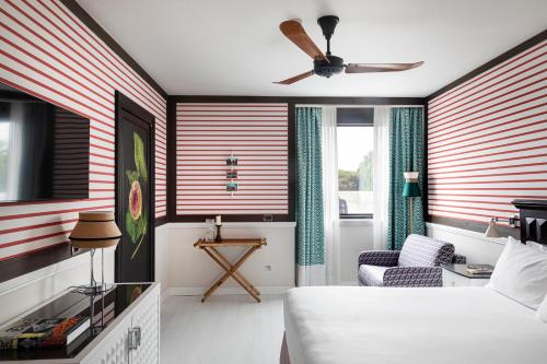 a hotel room with a bed and a ceiling fan at Savoy Hotel & Spa - Preferred Hotels & Resorts in Paestum
